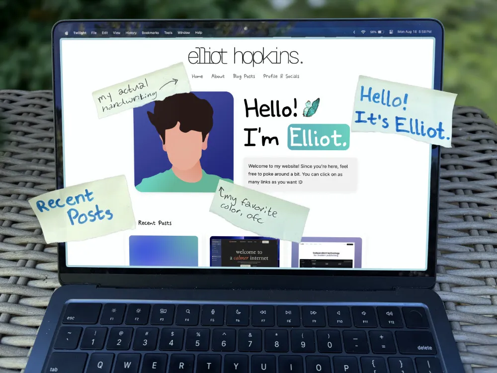 Laptop showing Elliot Hopkins’ website with sticky notes with comments on the design.